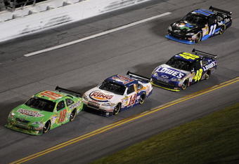 DAYTONA BEACH, FL - JULY 04: Kyle Busch driver of the #18 Interstate Batteries Toyota leads Tony Stewart driver of the #14 Burger King Chevrolet during the NASCAR Sprint Cup Series 51st Annual Coke Zero 400 at Daytona International Speedway on July 4, 2009 in Daytona Beach, Florida.  (Photo by John Harrelson/Getty Images for NASCAR)
