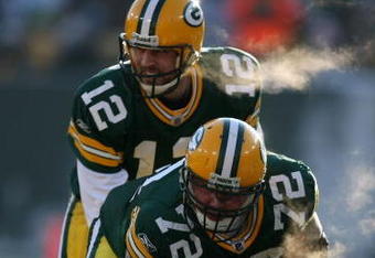 GREEN BAY, WI - DECEMBER 28: Aaron Rodgers #12 of the Green Bay Packers awaits the snap from George Foster #72 during a game against the Detroit Lions on December 28, 2008 at Lambeau Field in Green Bay, Wisconsin. The Packers defeated the Lions 31-21.  (Photo by Jonathan Daniel/Getty Images)