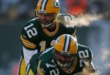 GREEN BAY, WI - DECEMBER 28: Aaron Rodgers #12 of the Green Bay Packers awaits the snap from George Foster #72 during a game against the Detroit Lions on December 28, 2008 at Lambeau Field in Green Bay, Wisconsin. The Packers defeated the Lions 31-21.  (Photo by Jonathan Daniel/Getty Images)