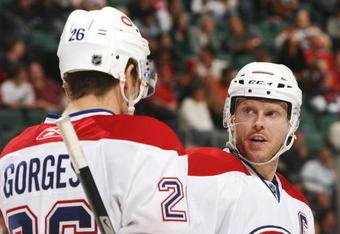 SUNRISE, FL - DECEMBER 28:  Saku Koivu #11 of the Montreal Canadiens talks with teammate Josh Gorges #26 just before a face-off against the Florida Panthers at Bank Atlantic Center December 28, 2007 in Sunrise, Florida. The Canadiens defeated the Panthers 5-1.  (Photo by Doug Benc/Getty Images)