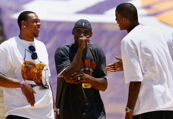 LOS ANGELES, CA - JUNE 17:  (L-R) Shannon Brown, Kobe Bryant and Trevor Ariza of the Los Angeles Lakers celebrate on stage during the 2009 NBA Championship Victory Parade and rally at the Los Angeles Memorial Coliseum on June 17, 2009 in Los Angeles, California.  (Photo by Jeff Gross/Getty Images)