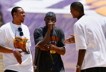 LOS ANGELES, CA - JUNE 17:  (L-R) Shannon Brown, Kobe Bryant and Trevor Ariza of the Los Angeles Lakers celebrate on stage during the 2009 NBA Championship Victory Parade and rally at the Los Angeles Memorial Coliseum on June 17, 2009 in Los Angeles, California.  (Photo by Jeff Gross/Getty Images)