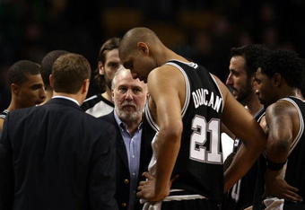 BOSTON - FEBRUARY 08:  Head coach Gregg Popovich of the San Antonio Spurs talks with his players during a time out against the Boston Celtics on February 8, 2009 at TD Banknorth Garden in Boston, Massachusetts. The Spurs defeated the Celtics 105-99. NOTE TO USER: User expressly acknowledges and agrees that, by downloading and or using this Photograph, user is consenting to the terms and conditions of the Getty Images License Agreement.  (Photo by Elsa/Getty Images)