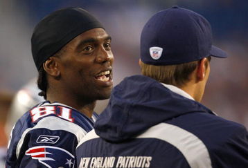 FOXBORO, MA - AUGUST 7: Randy Moss #81 and Tom Brady #12 of the New England Patriots  chat on the sideline against the Baltimore Ravens during the preseason game at Gillette Stadium on August 7, 2008 in Foxboro, Massachusetts. (Photo by Jim Rogash/Getty Images)