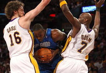 LOS ANGELES, CA - JUNE 07:  Dwight Howard #12 of the Orlando Magic is defended by Pau Gasol #16 and Lamar Odom #7 of the Los Angeles Lakers during Game Two of the 2009 NBA Finals at Staples Center on June 7, 2009 in Los Angeles, California. NOTE TO USER: User expressly acknowledges and agrees that, by downloading and or using this photograph, User is consenting to the terms and conditions of the Getty Images License Agreement.  (Photo by Jed Jacobsohn/Getty Images)