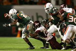 MIAMI - NOVEMBER 13:  Dorian Porch #24 of the Virginia Tech Hokies causes a fumble by running back Craig Cooper #2 of the Miami Hurricanes at Dolphin Stadium on November 13, 2008 in Miami, Florida. Miami defeated Virginia Tech 16-14.  (Photo by Doug Benc/Getty Images)