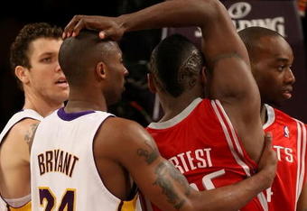 LOS ANGELES, CA - MAY 17:  Kobe Bryant #24 of the Los Angeles Lakers and Ron Artest #96 of the Houston Rockets get twisted up in the second quarter of Game Seven of the Western Conference Semifinals during the 2009 NBA Playoffs at Staples Center on May 17, 2009 in Los Angeles, California. NOTE TO USER: User expressly acknowledges and agrees that, by downloading and or using this photograph, User is consenting to the terms and conditions of the Getty Images License Agreement.  (Photo by Stephen Dunn/Getty Images)