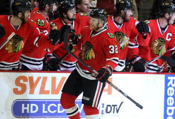 CHICAGO - MAY 11:  Kris Versteeg #32 of the Chicago Blackhawks celebrates with teammates on the bench after he scored a power play goal in the second period against the Vancouver Canucks during Game Six of the Western Conference Semifinal Round of the 2009 Stanley Cup Playoffs on May 11, 2009 at the United Center in Chicago, Illinois.  (Photo by Jonathan Daniel/Getty Images)