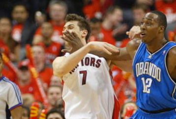 TORONTO,ON - APRIL 24:  Andrea Bargnani #7 of the Toronto Raptors takes a shot in the face from Dwight Howard #12 of the Orlando Magic in Game 3 of the Eastern Conference Quarterfinals on April 24, 2008 at the Air Canada Centre in Toronto, Ontario. The Raptors defeated the Magic 108-94. (Photo by Claus Andersen/Getty Images)