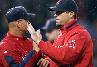 BOSTON - JULY 07:  Josh Beckett #19 of the Boston Red Sox celebrates the win with manager Terry Francona #47 after the game against the Oakland Athletics on July 7, 2009 at Fenway Park in Boston, Massachusetts. The Red Sox defeated the Athletics 5-2.  (Photo by Elsa/Getty Images)