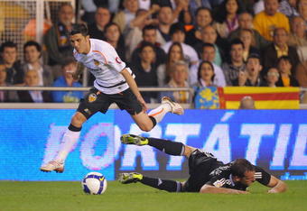 VALENCIA, SPAIN - MAY 09:  David Villa (L) of Valencia leaps over a beaten Cristoph Metzelder of Real Madrid during the La Liga match between Valencia and Real Madrid at the Mestalla stadium on May 9, 2009 in Valencia, Spain.  (Photo by Denis Doyle/Getty Images)