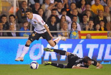 VALENCIA, SPAIN - MAY 09:  David Villa (L) of Valencia leaps over a beaten Cristoph Metzelder of Real Madrid during the La Liga match between Valencia and Real Madrid at the Mestalla stadium on May 9, 2009 in Valencia, Spain.  (Photo by Denis Doyle/Getty Images)
