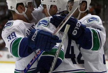 ANAHEIM, CA - SEPTEMBER 28:  Kyle Wellwood #42 of the Vancouver Canucks is congratulated by teammates Cody Hodgson #39 and Lawrence Nycholat #32 after Wellwood scored a second period goal against the Anaheim Ducks during the preseason NHL game at Honda Center on September 28, 2008 in Anaheim, California.  (Photo by Christian Petersen/Getty Images)