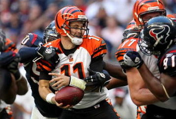 HOUSTON - OCTOBER 26:  Quarterback Ryan Fitzpatrick #11 of the Cincinnati Bengals is sacked and fumnbles by defensive end Marioi Williams #90 of the Houston Texans on October 26, 2008 at Reliant Stadium in Houston, Texas.  (Photo by Stephen Dunn/Getty Images)
