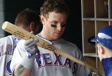 DETROIT - APRIL 10:  Josh Hamilton #32 of the Texas Rangers talks with a bat boy about his bat in the dugout while playing the Detroit Tigers during Opening Day on April 10, 2009 at Comerica Park in Detroit, Michigan.  (Photo by Gregory Shamus/Getty Images)