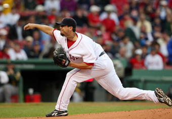 BOSTON - JULY 07:  Josh Beckett #19 of the Boston Red Sox delivers a pitch in the first inning against the Oakland Athletics on July 7, 2009 at Fenway Park in Boston, Massachusetts.  (Photo by Elsa/Getty Images)