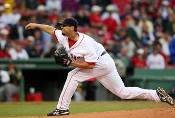 BOSTON - JULY 07:  Josh Beckett #19 of the Boston Red Sox delivers a pitch in the first inning against the Oakland Athletics on July 7, 2009 at Fenway Park in Boston, Massachusetts.  (Photo by Elsa/Getty Images)
