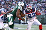 EAST RUTHERFORD, NJ - DECEMBER 14:  Marshawn Lynch #23 of the Buffalo Bills attempts to elude the tackle of Calvin Pace #97 of the New York Jets during their game on December 14, 2008 at Giants Stadium in East Rutherford, New Jersey.  (Photo by Al Bello/Getty Images)