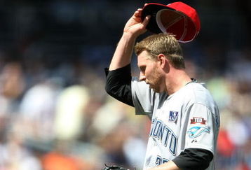 NEW YORK - JULY 04:  Roy Halladay #32 of the Toronto Blue Jays removes his hat against the New York Yankees on July 4, 2009 at Yankee Stadium in the Bronx borough of New York City.  (Photo by Nick Laham/Getty Images)