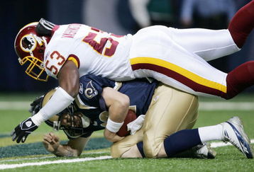 ST. LOUIS - DECEMBER 4:  Marcus Washington #53 of the Washington Redskins sacks Ryan Fitzpatrick #12 of the St. Louis Rams on December 4, 2005 at the Edward Jones Dome in St. Louis, Missouri.  (Photo by Elsa/Getty Images)