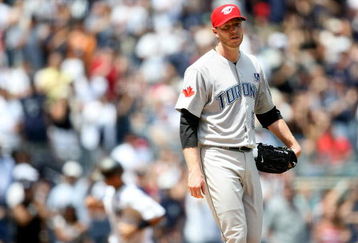 NEW YORK - JULY 04:  Roy Halladay #32 of the Toronto Blue Jays reacts after Jorge Posada #20 of the New York Yankees hit a home run in the fourth inning on July 4, 2009 at Yankee Stadium in the Bronx borough of New York City.  (Photo by Nick Laham/Getty Images)