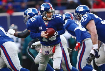 EAST RUTHERFORD, NJ -  JANUARY 11:  Eli Manning #10 of the New York Giants looks to hand off the ball against the Philadelphia Eagles during the NFC Divisional Playoff Game on January 11, 2009 at Giants Stadium in East Rutherford, New Jersey.  The Eagles defeated the Giants 23 -11. (Photo by Chris McGrath/Getty Images)
