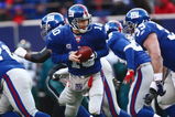 EAST RUTHERFORD, NJ -  JANUARY 11:  Eli Manning #10 of the New York Giants looks to hand off the ball against the Philadelphia Eagles during the NFC Divisional Playoff Game on January 11, 2009 at Giants Stadium in East Rutherford, New Jersey.  The Eagles defeated the Giants 23 -11. (Photo by Chris McGrath/Getty Images)