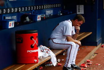 ATLANTA - JUNE 27:  Chipper Jones #10 of the Atlanta Braves sits dejected in the dugout after falling to the Boston Red Sox 1-0 at Turner Field on June 27, 2009 in Atlanta, Georgia.  (Photo by Kevin C. Cox/Getty Images)