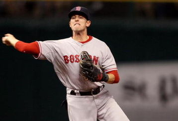ST. PETERSBURG, FL - OCTOBER 11:  Jed Lowrie #12 of the Boston Red Sox fields a hit by Jason Bartlett #8 of the Tampa Bay Rays in the sixth inning of game two of the American League Championship Series during the 2008 MLB playoffs at Tropicana Field on October 11, 2008 in St. Petersburg, Florida.  (Photo by Elsa/Getty Images)