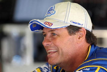 LOUDON, NH - JUNE 27:  Michael Waltrip, driver of the #55 NAPA Toyota, stands next to his car in the garage during practice for the NASCAR Sprint Cup Series LENOX Industrial Tools 301 at New Hampshire Motor Speedway on June 27, 2009 in Loudon, New Hampshire.  (Photo by Drew Hallowell/Getty Images for NASCAR)