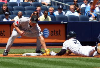 NEW YORK - JULY 06:  Derek Jeter #2 of the New York Yankees is tagged out on a first inning steal attempt of third base by Scott Rolen #33 of the Toronto Blue Jays on July 6, 2009 at Yankee Stadium in the Bronx borough of New York City.  (Photo by Jim McIsaac/Getty Images)