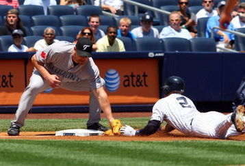 NEW YORK - JULY 06:  Derek Jeter #2 of the New York Yankees is tagged out on a first inning steal attempt of third base by Scott Rolen #33 of the Toronto Blue Jays on July 6, 2009 at Yankee Stadium in the Bronx borough of New York City.  (Photo by Jim McIsaac/Getty Images)
