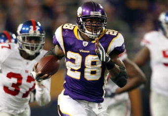 MINNEAPOLIS - DECEMBER 28:   Adrian Peterson #28 of the Minnesota Vikings runs the ball in for a touchdown as James Butler of the New York Giants defends on December 28, 2008 at the Hubert H. Humphrey Metrodome in Minneapolis, Minnesota. The Vikings defeated the Giants 20-19. (Photo by Elsa/Getty Images)