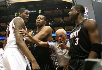ATLANTA - APRIL 29:  Official Dick Bavetta #27 steps in between Dwyane Wade #3, Jamaal Magloire #21 of the Miami Heat and Solomon Jones #44 of the Atlanta Hawks after Wade was fouled hard during Game Five of the Eastern Conference Quarterfinals at Philips Arena on April 29, 2009 in Atlanta, Georgia. NOTE TO USER: User expressly acknowledges and agrees that, by downloading and/or using this Photograph, user is consenting to the terms and conditions of the Getty Images License Agreement.  (Photo by Doug Benc/Getty Images)