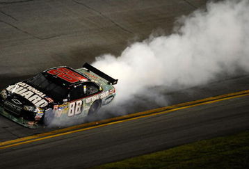 DAYTONA BEACH, FL - JULY 04: Dale Earnhardt Jr, driver of the #88 National Guard/AMP Energy Chevrolet, drives while smoke flows out of his car after  driving away from an on track collision during the NASCAR Sprint Cup Series 51st Annual Coke Zero 400 at Daytona International Speedway on July 4, 2009 in Daytona Beach, Florida.  (Photo by John Harrelson/Getty Images for NASCAR)