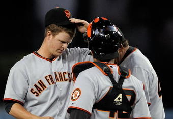 LOS ANGELES, CA - APRIL 15:  Pitcher Matt Cain #18 (L) of the San Francisco Giants gets visit from catcher Bengie Molina #1 and pitching coach Dave Righetti #44 after giving up a bases loaded walk to James Loney #7 of the Los Angeles Dodgers to score Orlando Hudson #13 from thrid base during the first inning of the baseball game at Dodger Stadium on April 15, 2009 in Los Angeles, California. All Major League Baseball players are wearing #42 in honor of Jackie Robinson day.  (Photo by Kevork Djansezian/Getty Images)