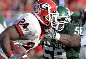 ORLANDO, FL - JANUARY 1: Defensive end Trevor Anderson #58 of the Michigan State Spartans tries to tackle running back Knowshon Moreno #24 of the University of Georgia during the 2009 Capital One Bowl at the Citrus Bowl on January 1, 2009 in Orlando, Florida.  (Photo by Al Messerschmidt/Getty Images)