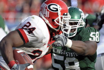 ORLANDO, FL - JANUARY 1: Defensive end Trevor Anderson #58 of the Michigan State Spartans tries to tackle running back Knowshon Moreno #24 of the University of Georgia during the 2009 Capital One Bowl at the Citrus Bowl on January 1, 2009 in Orlando, Florida.  (Photo by Al Messerschmidt/Getty Images)