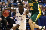 MINNEAPOLIS - MARCH 20:  Sherron Collins #4 of the Kansas Jayhawks drives the ball in the second half against Josh Vaughn #32 of the North Dakota State Bison during the first round of the NCAA Division I Men's Basketball Tournament at the Hubert H. Humphrey Metrodome on March 20, 2009 in Minneapolis, Minnesota.  (Photo by Jonathan Daniel/Getty Images)
