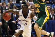 MINNEAPOLIS - MARCH 20:  Sherron Collins #4 of the Kansas Jayhawks drives the ball in the second half against Josh Vaughn #32 of the North Dakota State Bison during the first round of the NCAA Division I Men's Basketball Tournament at the Hubert H. Humphrey Metrodome on March 20, 2009 in Minneapolis, Minnesota.  (Photo by Jonathan Daniel/Getty Images)