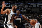 SAN ANTONIO - APRIL 28:  Forward Josh Howard #5 of the Dallas Mavericks dribbles the ball past Tim Duncan #21 of the San Antonio Spurs in Game Five of the Western Conference Quarterfinals during the 2009 NBA Playoffs at AT&T Center on April 28, 2009 in San Antonio, Texas. NOTE TO USER: User expressly acknowledges and agrees that, by downloading and or using this photograph, User is consenting to the terms and conditions of the Getty Images License Agreement.  (Photo by Ronald Martinez/Getty Images)