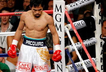 LAS VEGAS - MAY 02:  Manny Pacquiao of the Philippines looks down at referee Kenny Bayless counting after Ricky Hatton of England was knocked down in the first round during their junior welterweight title fight at the MGM Grand Garden Arena May 2, 2009 in Las Vegas, Nevada.  (Photo by Ethan Miller/Getty Images)