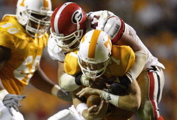 KNOXVILLE, TN - OCTOBER 11:  Quarterback Casey Clausen #7 of the Tennessee Volunteers is sacked by David Pollack #47 of the Georgia Bulldogs in the second half on October 11, 2003 at Neyland Stadium in Knoxville, Tennessee. Georgia defeated Tennessee 41-14.  (Photo by Elsa/Getty Images)