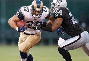 OAKLAND, CA - AUGUST 24:  Running back Brian Leonard #23 of the St. Louis Rams fights for yards as defensive back Michael Huff #24 of the Oakland Raiders tackles him during a preseason game on August 24, 2007 at McAfee Coliseum in Oakland, California.  (Photo by Greg Trott/Getty Images)