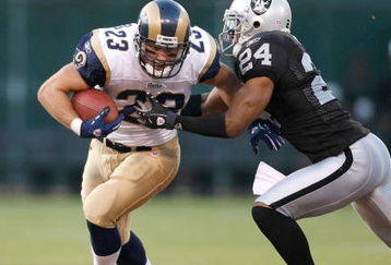 OAKLAND, CA - AUGUST 24:  Running back Brian Leonard #23 of the St. Louis Rams fights for yards as defensive back Michael Huff #24 of the Oakland Raiders tackles him during a preseason game on August 24, 2007 at McAfee Coliseum in Oakland, California.  (Photo by Greg Trott/Getty Images)