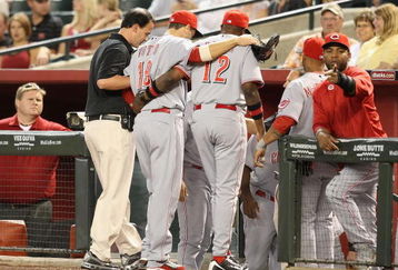 PHOENIX - MAY 12:  Joey Votto #19 of the Cincinnati Reds is helped off the field by manager Dusty Baker during the major league baseball game against the Arizona Diamondbacks at Chase Field on May 12, 2009 in Phoenix, Arizona.  (Photo by Christian Petersen/Getty Images)
