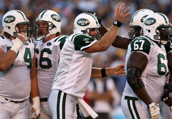 SAN DIEGO - SEPTEMBER 22:  Quarterback Brett Favre #4 of the New York Jets celebrates with teammate D'Brickashaw Ferguson #60 after throwing a three-yard touchdown pass against the San Diego Chargers in the second quarter on September 22, 2008 at Qualcomm Stadium in San Diego, California. The Chargers defeated the Jets 48-29.  (Photo by Stephen Dunn/Getty Images)