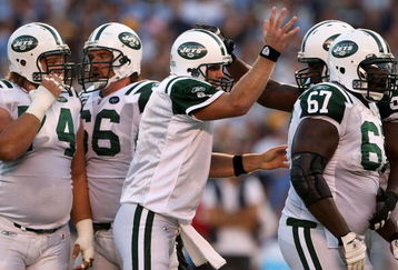 SAN DIEGO - SEPTEMBER 22:  Quarterback Brett Favre #4 of the New York Jets celebrates with teammate D'Brickashaw Ferguson #60 after throwing a three-yard touchdown pass against the San Diego Chargers in the second quarter on September 22, 2008 at Qualcomm Stadium in San Diego, California. The Chargers defeated the Jets 48-29.  (Photo by Stephen Dunn/Getty Images)