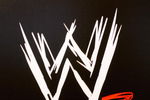 NEW YORK - MARCH 18:  The World Wrestling Entertainment logo hangs on a wall at a media conference announcing the all-star lineup of WWE WrestleMania XIX at ESPN Zone in Times Square March 18, 2003 in New York City.  (Photo by Mark Mainz/Getty Images)