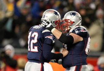 FOXBORO, MA - JANUARY 20:  (L-R) Tom Brady #12 and Dan Koppen #67 of the New England Patriots celebrate after Brady threw a 6-yard touchdown to Wes Welker #83 in the fourth quarter against the San Diego Chargers during the AFC Championship Game on January 20, 2008 at Gillette Stadium in Foxboro, Massachusetts.  (Photo by Al Bello/Getty Images)